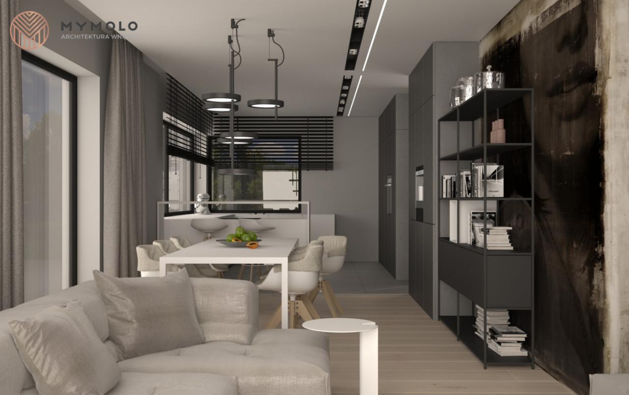 Wizualizacja wnętrza mieszkania z salonem połączonym z kuchnią, szara kolorystyka, nowoczesne oświetlenie, minimalistyczne meble, regał z książkami i dekoracjami, duży obraz na ścianie.