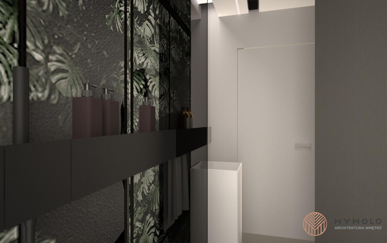 Wizualizacja łazienki z motywem tropikalnych liści na ścianie, minimalistyczną umywalką i czarną półką z dozownikami na mydło, prezentująca nowoczesny design wnętrza.