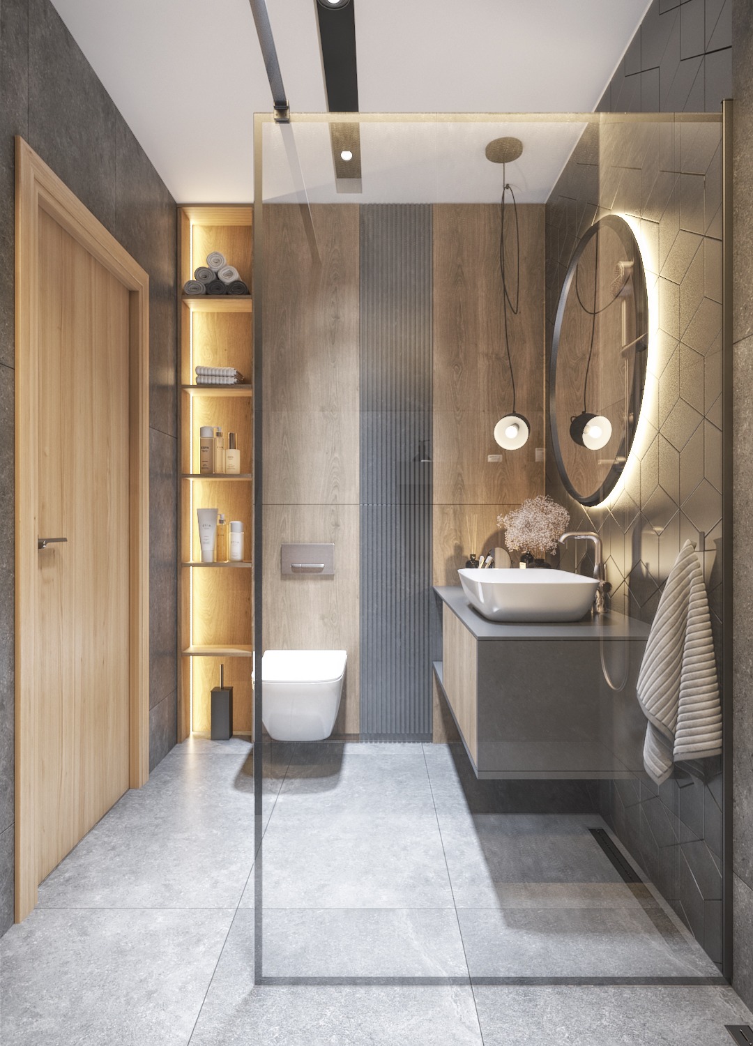 Nowoczesna łazienka z kabiną prysznicową typu walk-in, wiszącą toaletą, umywalką nablatową i okrągłym lustrem z podświetleniem LED, akcenty drewniane i szare płytki.