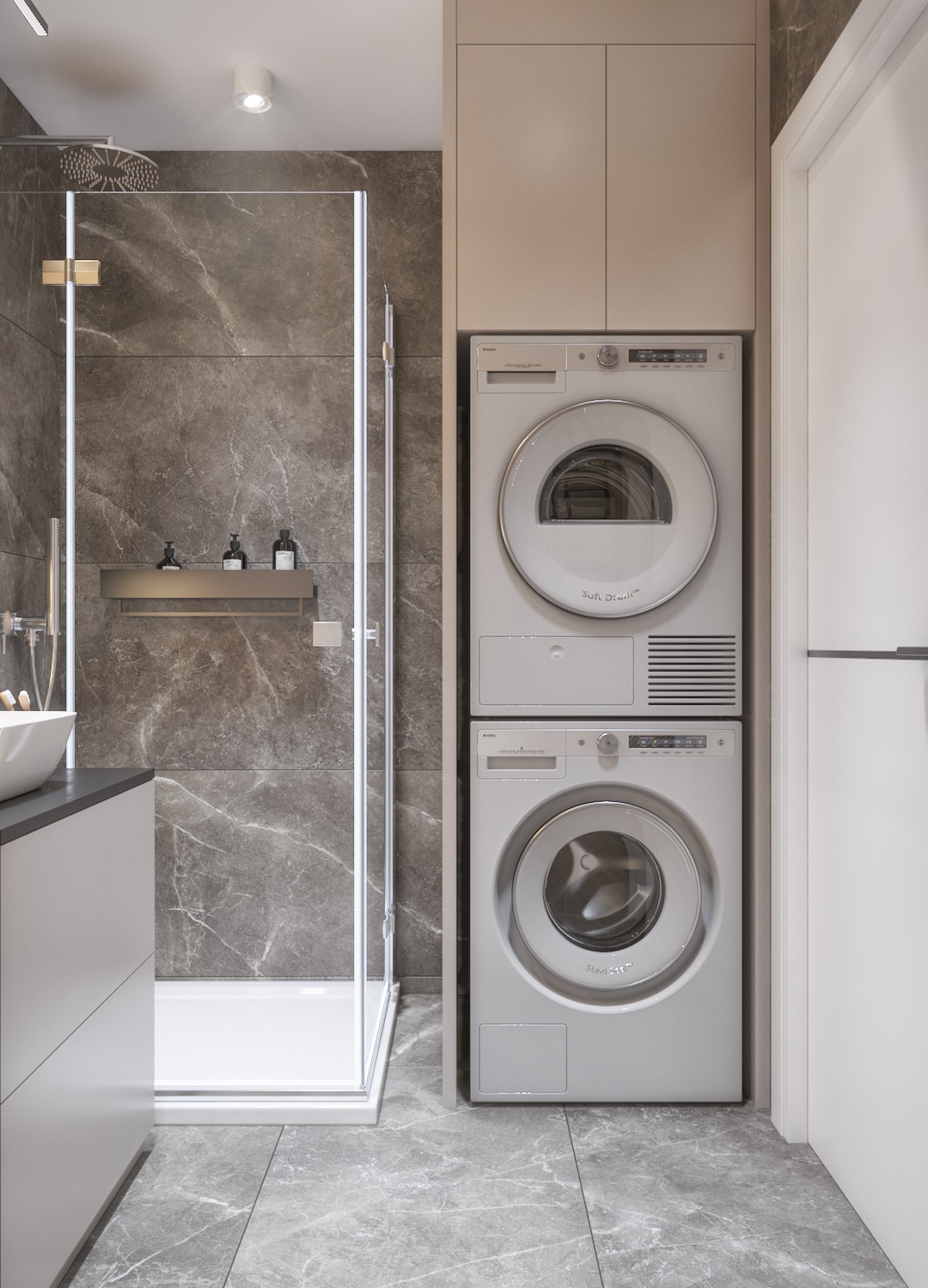 Nowoczesna łazienka z kabiną prysznicową typu walk-in, marmurowymi płytkami ściennymi, białą umywalką nablatową i pralko-suszarką w zabudowie, oświetlona punktowym światłem.