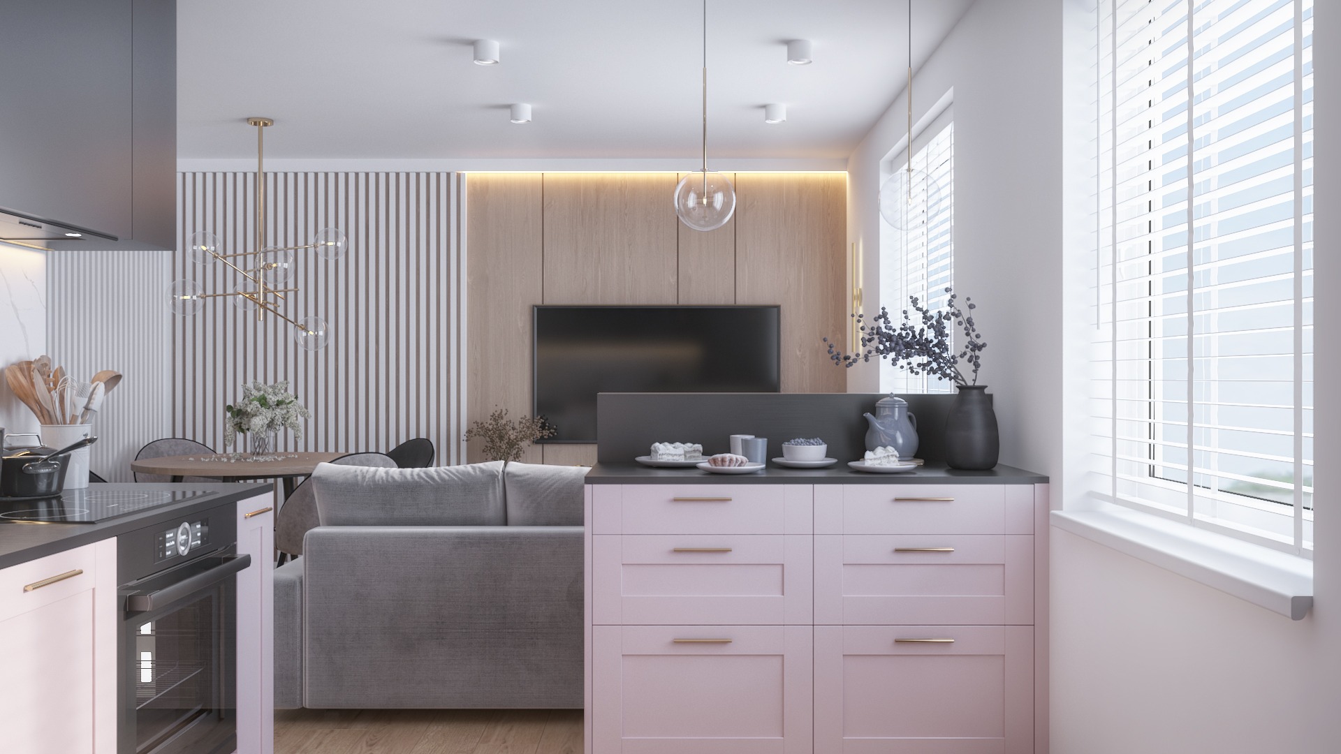 Nowoczesne wnętrze: pastelowa zabudowa kuchenna z szarą sofą, okrągły stół z designerską lampą i panele ścienne z telewizorem w tle.