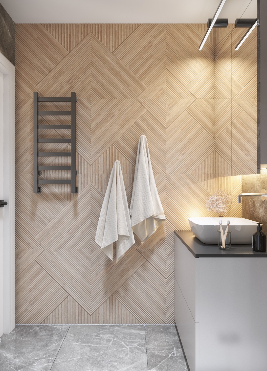Nowoczesna łazienka z drewnianą ścianą z geometrycznym wzorem, wiszącymi ręcznikami, grzejnikiem drabinkowym i umywalką nablatową z czarnym blatem.