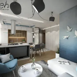 Wizualizacja nowoczesnego salonu z aneksem kuchennym, z niebieskim akcentem na ścianie i dekoracją w postaci białych ptaków, widoczne designerskie lampy i turkusowy fotel.