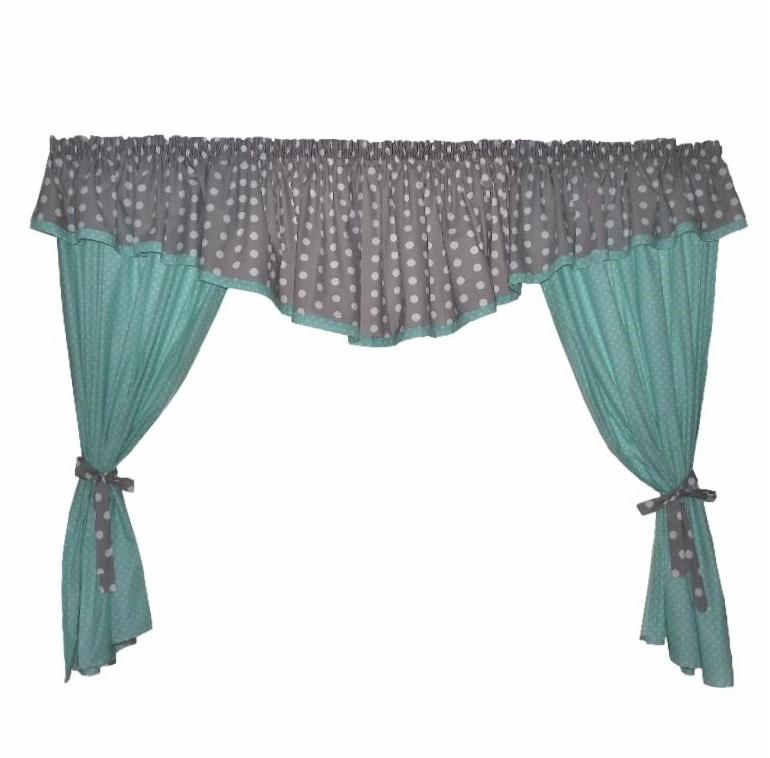 Gotowa firanka w kolorze szarym z białymi kropkami i turkusowym podszyciem, upięta w dwóch miejscach szarymi kokardkami w białe kropki.