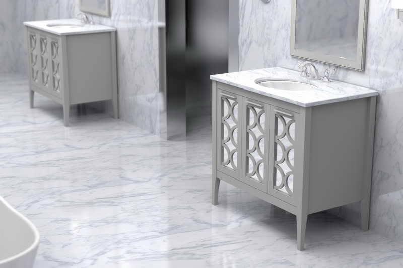 Szara szafka łazienkowa z marmurowym blatem i dekoracyjnymi drzwiczkami na tle marmurowej podłogi i ściany, w tle widoczna druga szafka.