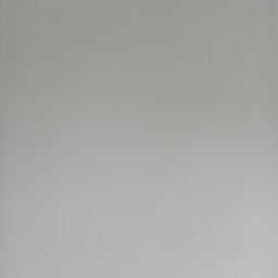 Kraw-bud - Gładka, szara ściana w neutralnym oświetleniu, bez widocznych faktur i detali.