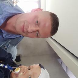 Remix - Mężczyzna z kluczykami do samochodu i małe dziecko z smoczkiem na tle jasnej ściany