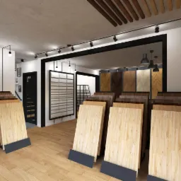 Ekspozycja różnorodnych paneli podłogowych w salonie, prezentująca wzory i odcienie drewna, z widocznymi próbkami ułożonymi na podłodze z jasnego drewna.