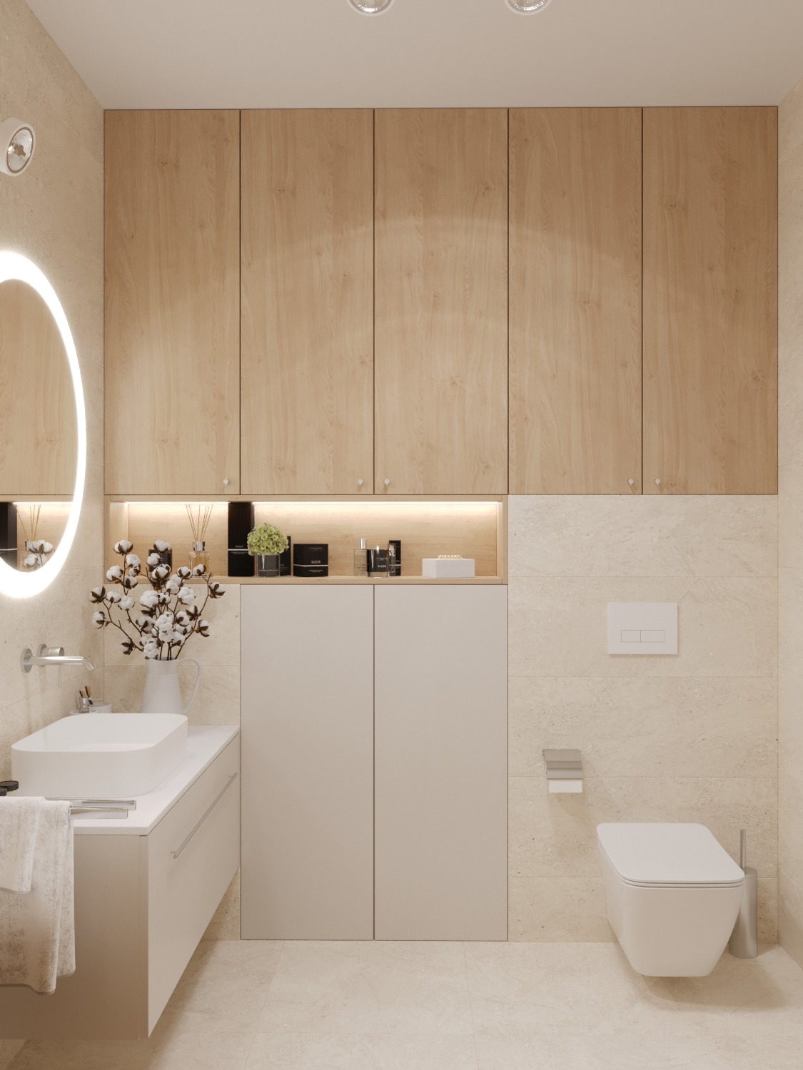 Jasna łazienka z drewnianą zabudową szafek nad toaletą i umywalką. Okrągłe lustro z podświetleniem LED. Minimalistyczny styl, beżowe płytki na ścianach i podłodze.