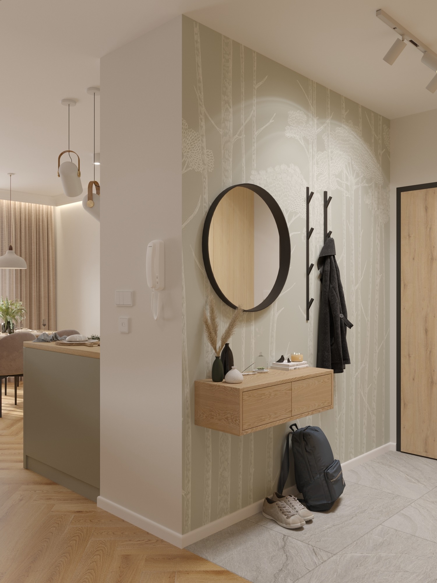 Nowoczesny przedpokój z okrągłym lustrem, drewnianą konsolą i wieszakiem na płaszcze. Tapeta w motywie leśnym, parkiet w jodełkę i szara podłoga tworzą spójną całość.