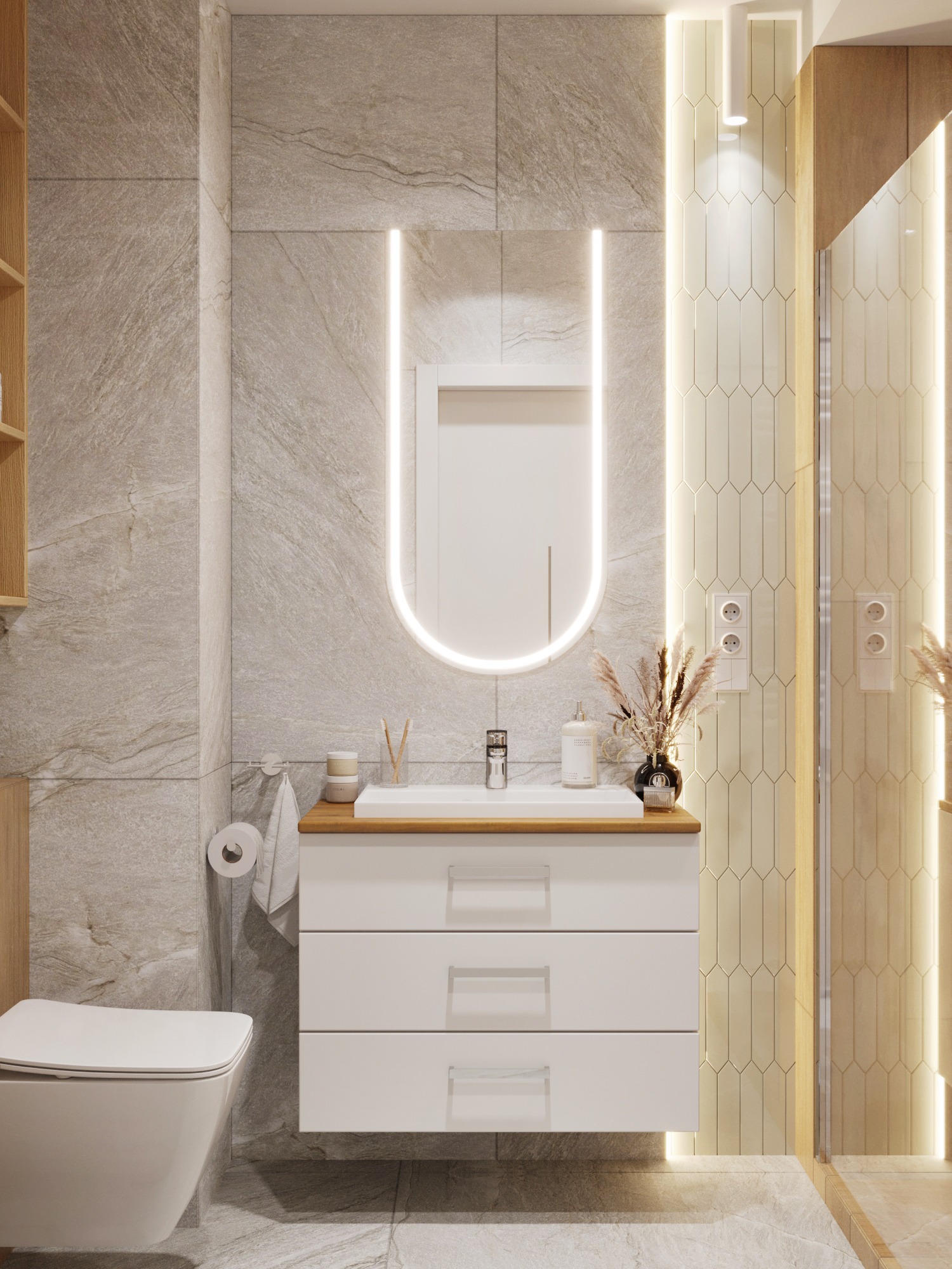 Nowoczesna łazienka z podświetlanym lustrem, umywalką z szafką i toaletą w odcieniach szarości i bieli. Minimalistyczny design z akcentami drewna i dekoracyjnymi trawami.