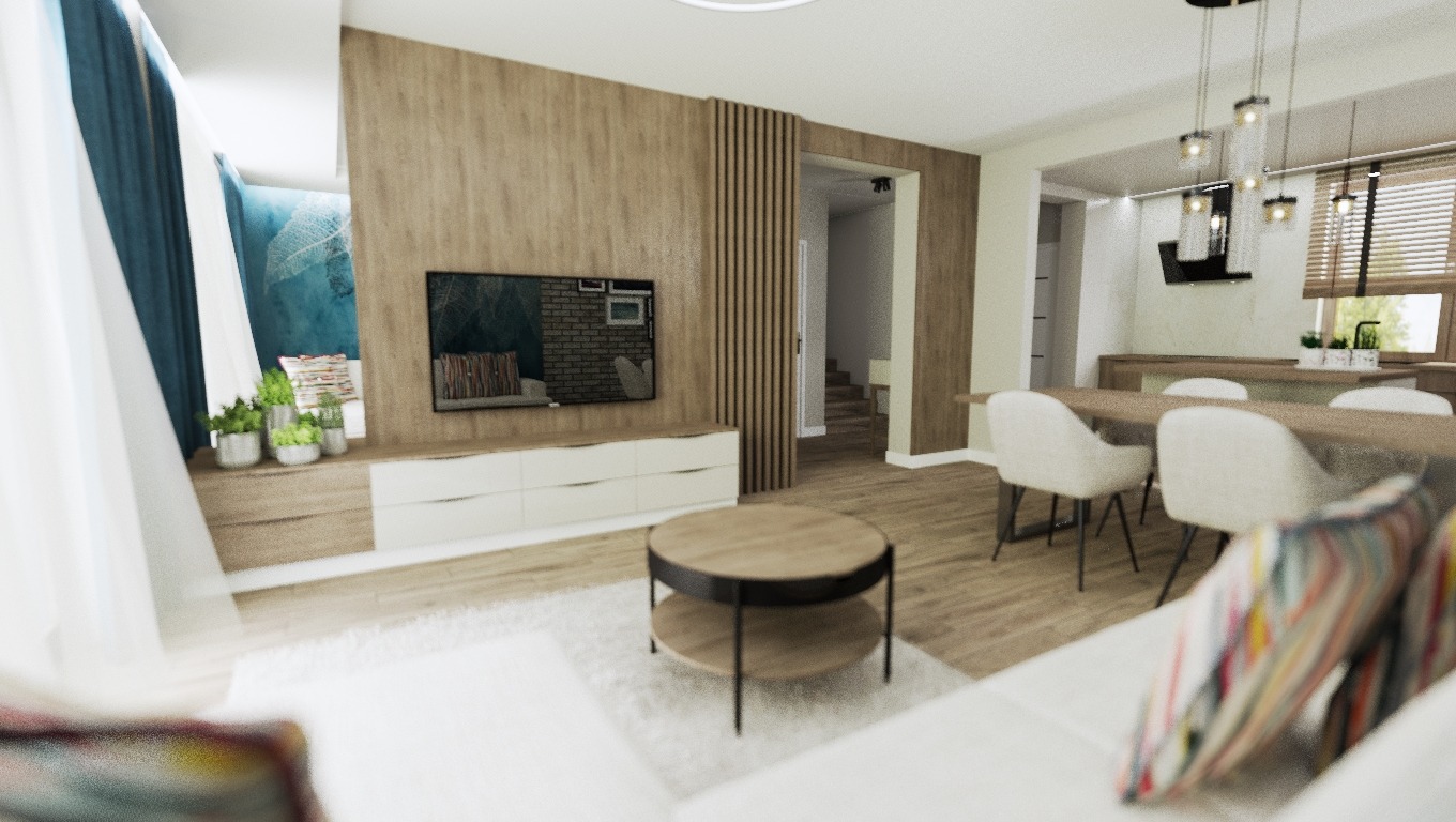 Jasne, przestronne wnętrze salonu z drewnianą ścianą, telewizorem i niską komodą. Okrągły stolik kawowy na puszystym dywanie. W tle jadalnia z drewnianym stołem i krzesłami. Niebieskie zasłony po...