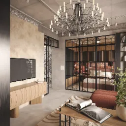 Nowoczesny salon z designerskim oświetleniem sufitowym, telewizorem na drewnianej szafce RTV, szklaną ścianą oddzielającą sypialnię i dywanem w geometryczne wzory.