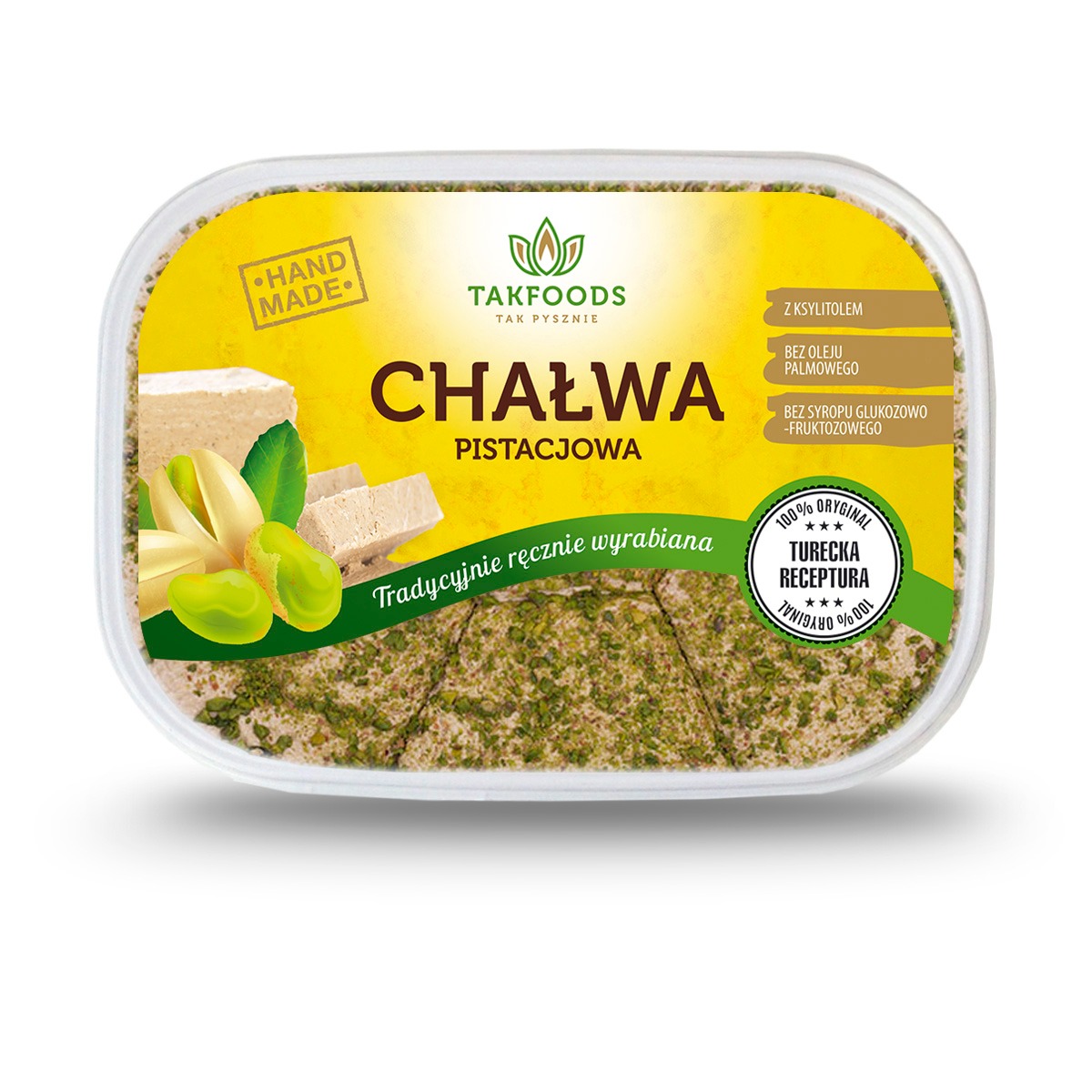 Opakowanie chałwy pistacjowej marki Takfoods z informacją o ręcznym wyrobie i braku oleju palmowego, syropu glukozowo-fruktozowego oraz dodatkiem ksylitolu, z widocznymi pistacjami i kawałkami chałwy.