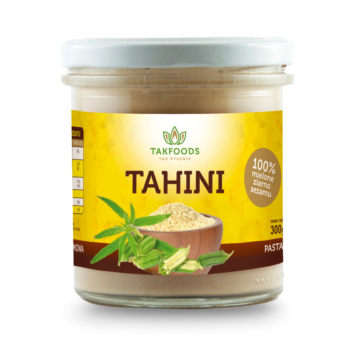 Słoik tahini marki Takfoods z widocznym ziarnem sezamu i gałązką sezamu na etykiecie, na białym tle.