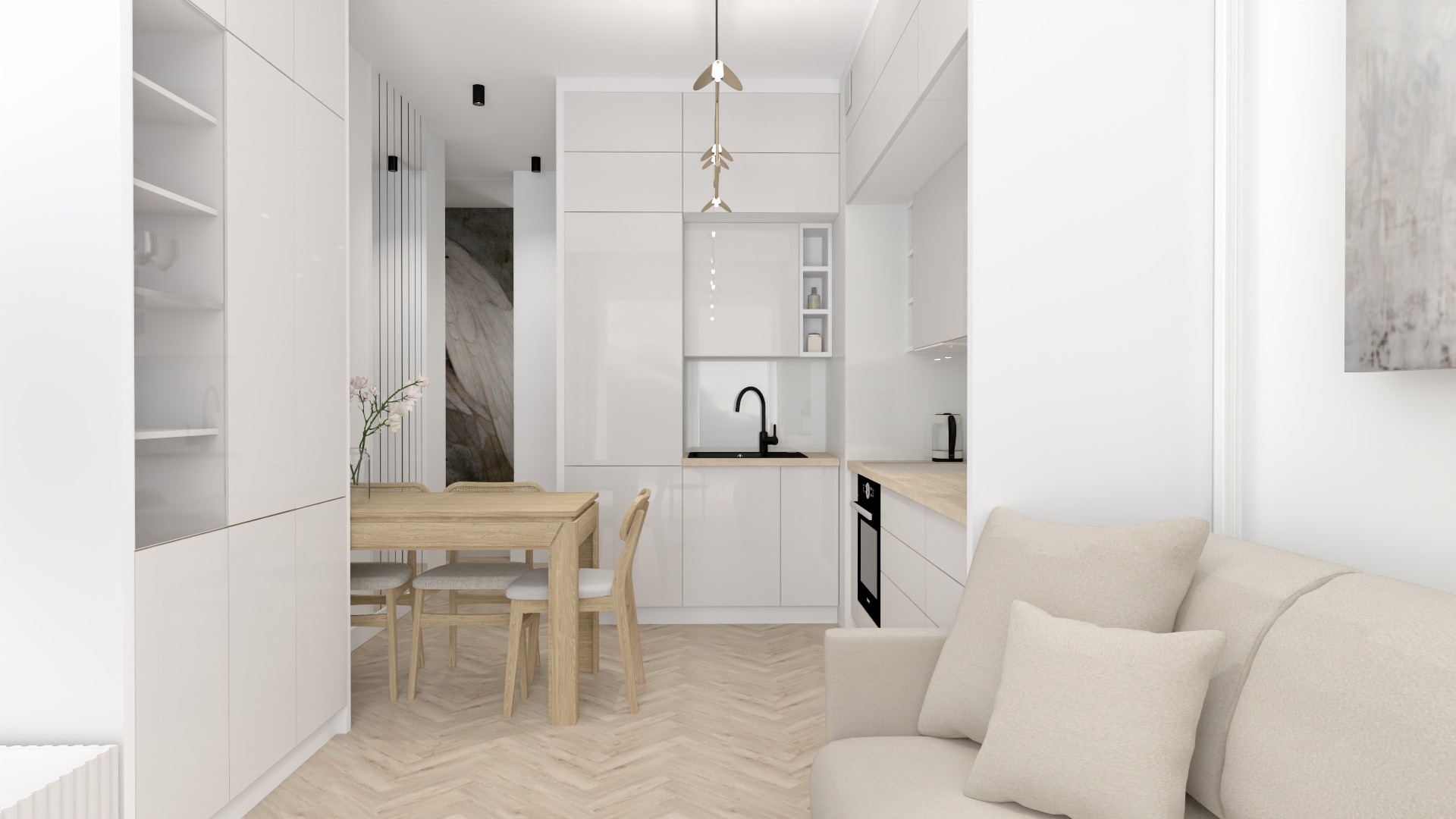 Jasne wnętrze z aneksem kuchennym, drewnianym stołem i krzesłami, oraz beżową sofą z poduszkami, oświetlone nowoczesną lampą wiszącą.