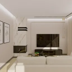 Jasne wnętrze salonu z kominkiem obłożonym marmurem, minimalistycznym telewizorem i kremową sofą. Na ścianie grafiki w czarnych ramach.