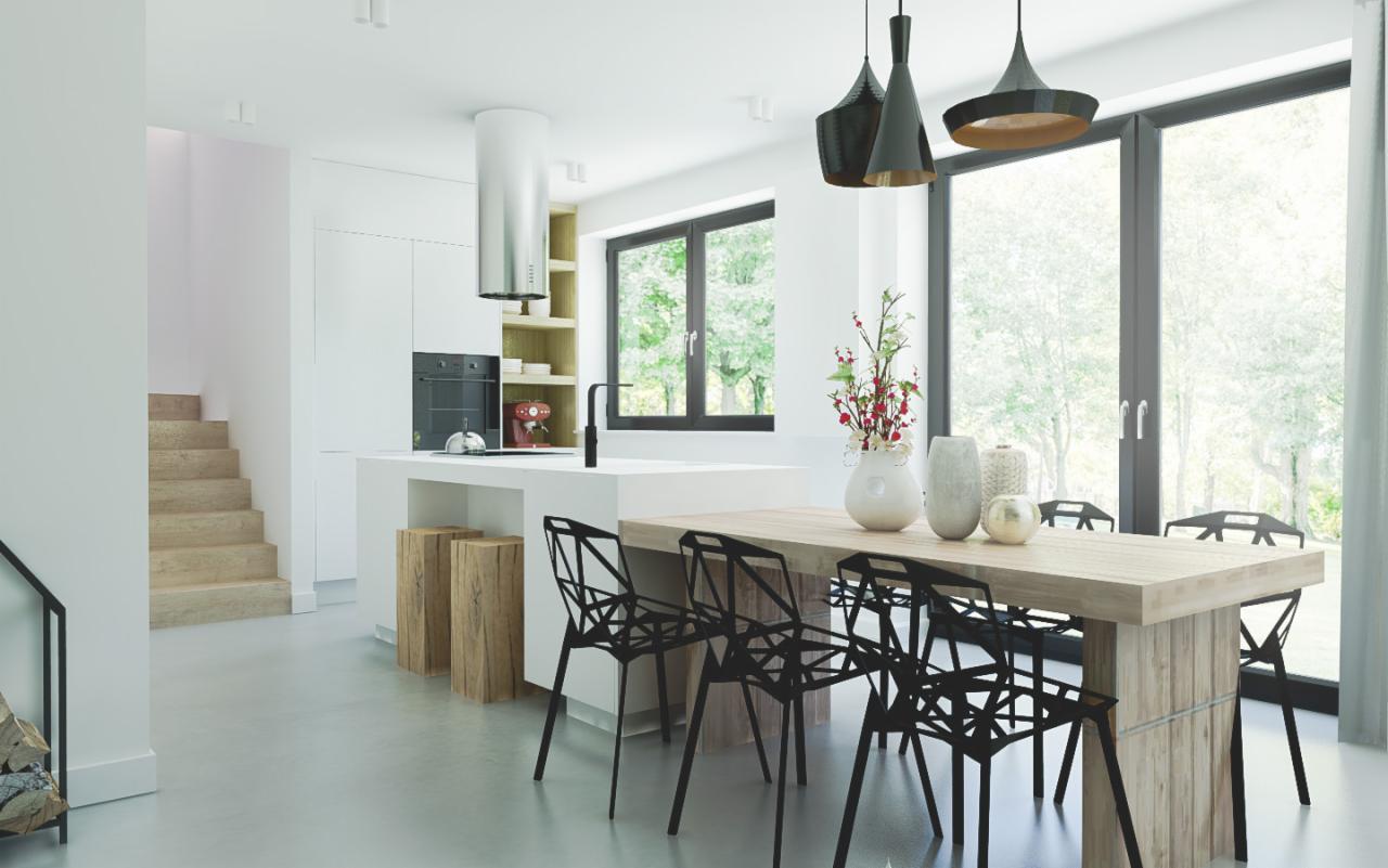 Jasne, nowoczesne wnętrze: kuchnia z wyspą, drewniany stół z czarnymi krzesłami, minimalistyczne oświetlenie i widok na zieleń za oknem.