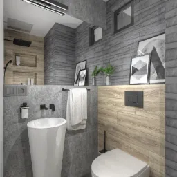 Nowoczesna łazienka z umywalką wolnostojącą, wiszącą toaletą i szarą ścianą z dekoracyjnymi obrazkami oraz drewnianymi panelami, oświetlona podłużną lampą sufitową.