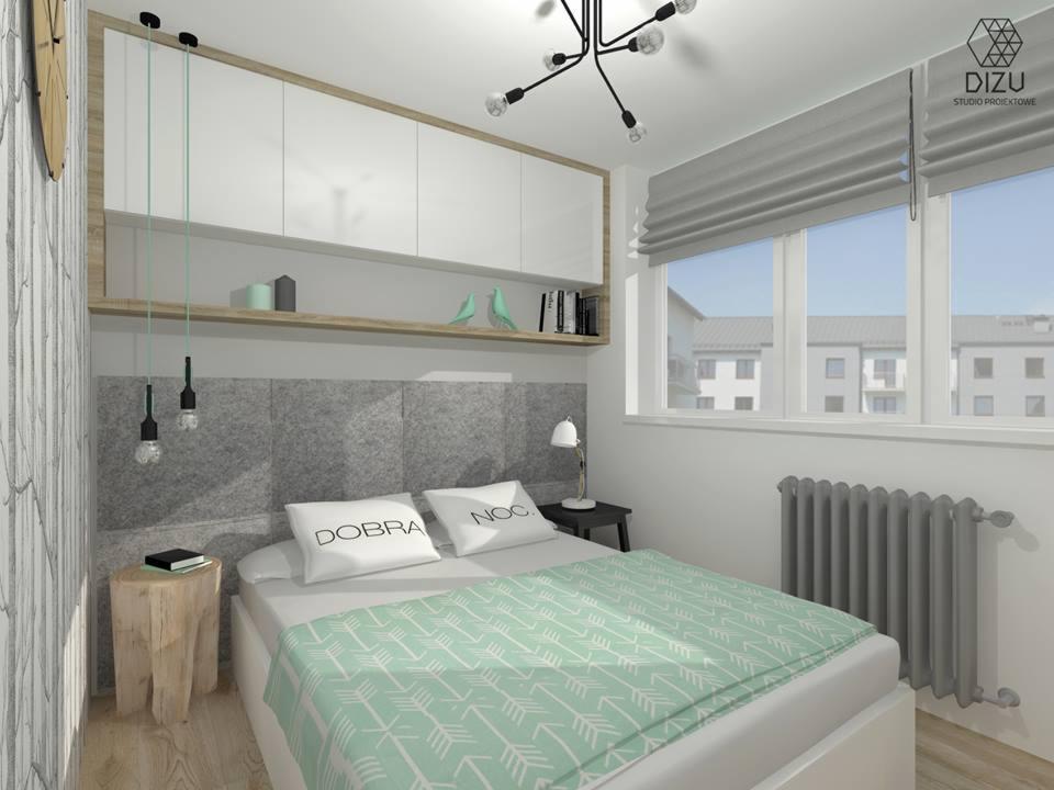 Wizualizacja sypialni w szaro-białej tonacji z drewnianymi akcentami, z podwieszanymi szafkami, szarą tapetą za łóżkiem, lampami wiszącymi na długich kablach i grzejnikiem pod oknem.