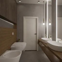 Nowoczesna łazienka z drewnianymi akcentami: wiszące szafki, umywalki nablatowe z złotą armaturą, podświetlane lustra, toaleta i bidet.