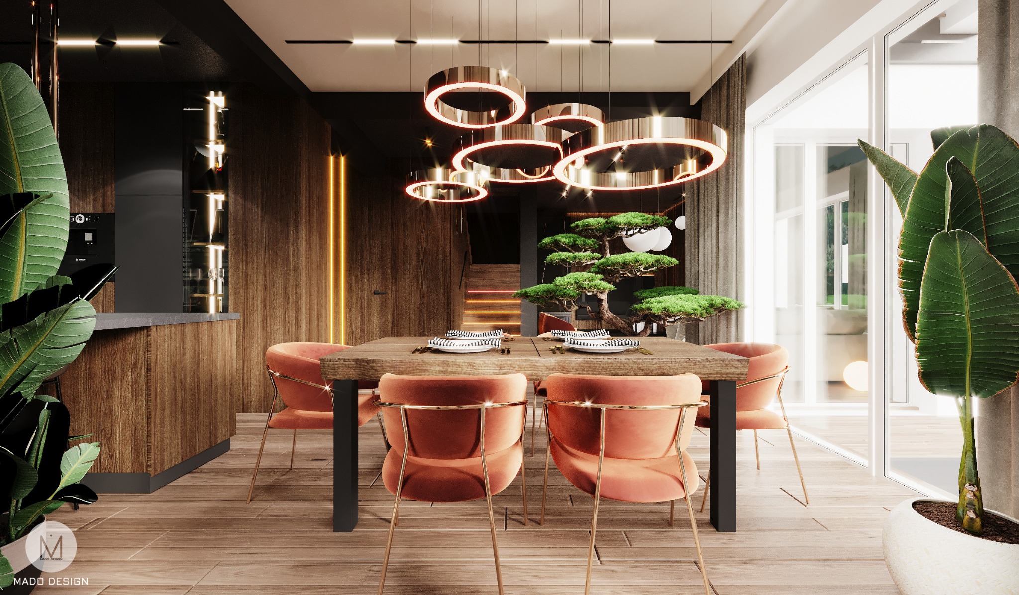Nowoczesna jadalnia z drewnianym stołem, krzesłami w kolorze brzoskwiniowym na złotych nogach, designerskim oświetleniem pierścieniowym i bonsai na stole. Widoczna kuchnia z drewnianymi frontami...