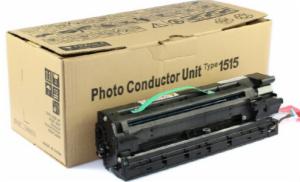Zespół światłoczuły (Photo Conductor Unit Type 1515) do kserokopiarki, leżący obok kartonowego pudełka z nadrukowanymi ikonami i tekstem informacyjnym.