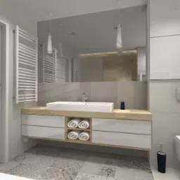 Jasna łazienka z kabiną prysznicową, umywalką na szafce z drewnianym blatem, wiszącą toaletą i mozaikową podłogą.