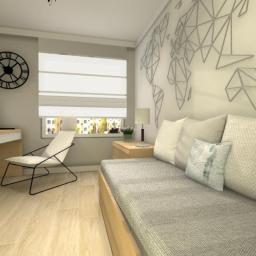Malaga - Jasny pokój z łóżkiem, biurkiem z laptopem i dekoracją ścienną w kształcie mapy świata z geometrycznych figur. Na biurku stoi zegar.