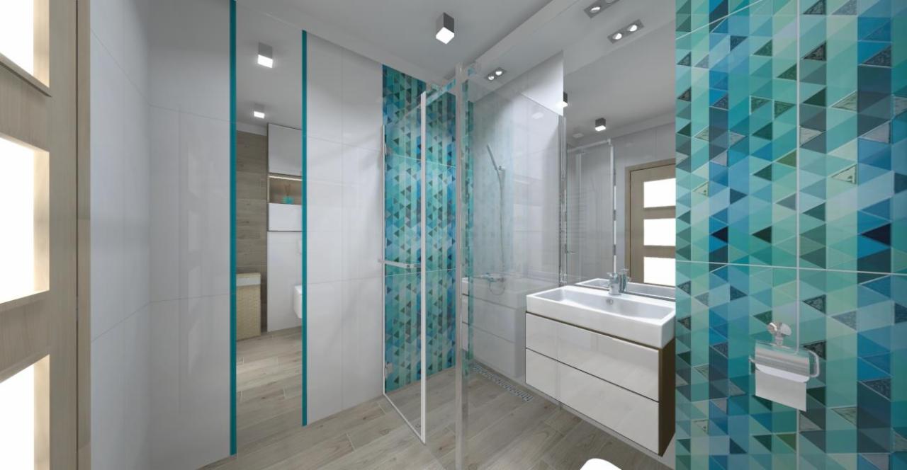 Wizualizacja nowoczesnej łazienki z kabiną prysznicową, umywalką nablatową z szafką i płytkami w odcieniach błękitu i turkusu z geometrycznym wzorem trójkątów.