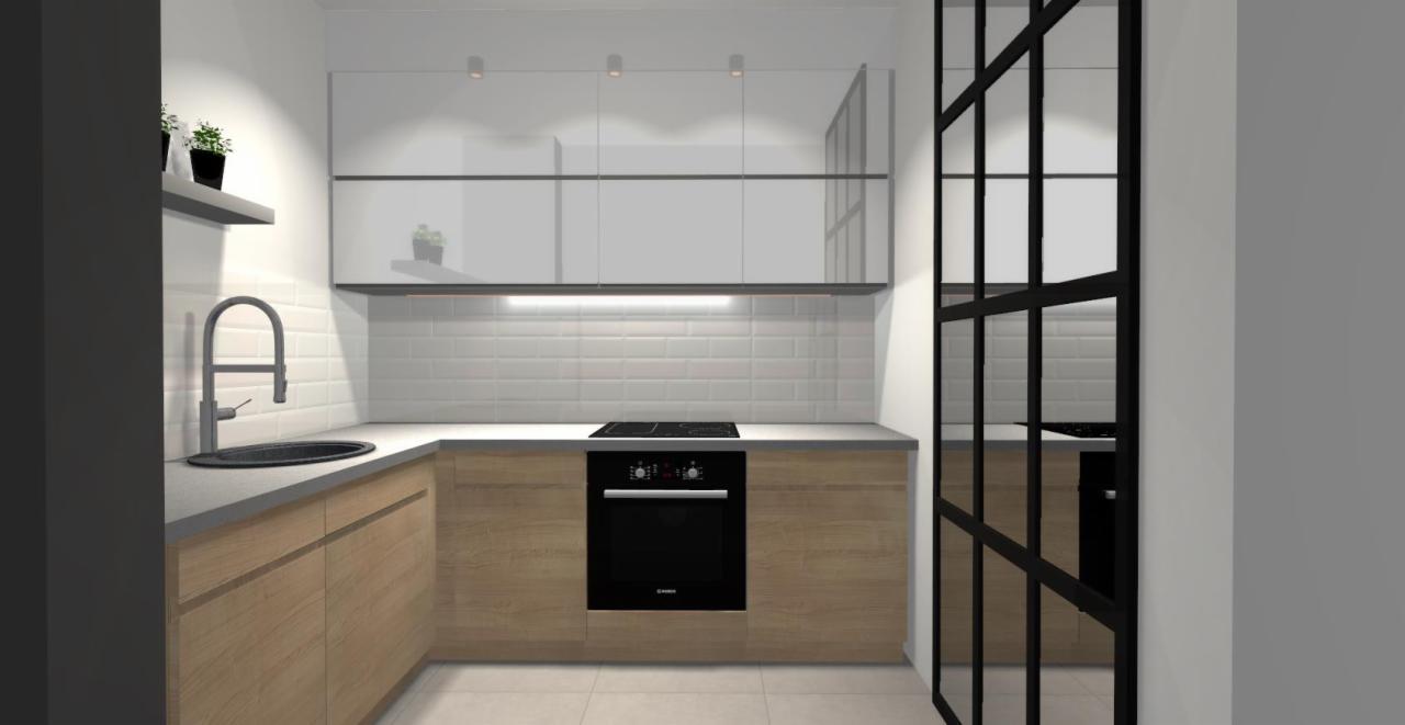 Wizualizacja nowoczesnej kuchni z drewnianymi frontami szafek, białymi płytkami na ścianie i czarnymi akcentami, w tym piekarnikiem i przeszklonymi drzwiami w stylu industrialnym.
