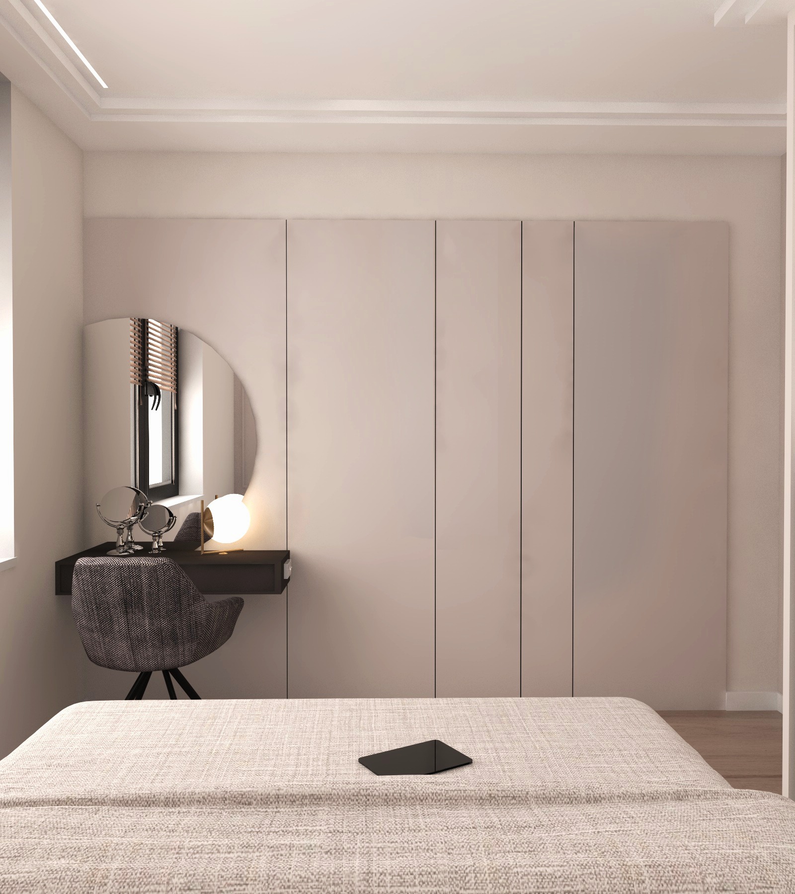 Nowoczesna sypialnia z toaletką z okrągłym lustrem, szarą tapicerowaną pufą i minimalistyczną lampką na tle beżowej szafy wnękowej.