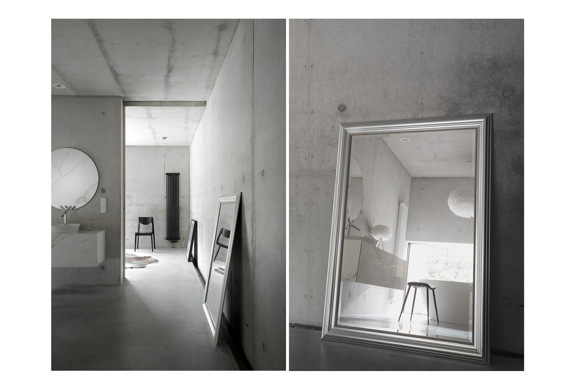 Surowe, industrialne wnętrze łazienki z betonowymi ścianami, dużym okrągłym lustrem nad umywalką i dwoma lustrami w ozdobnych ramach opartymi o ścianę.