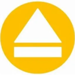 Żółte koło z białym symbolem: trójkąt skierowany w górę nad prostokątem. Symbolizuje kierunek wyjścia ewakuacyjnego.