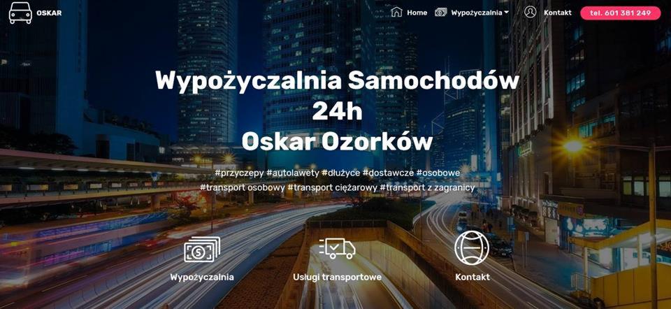 Strona internetowa wypożyczalni samochodów Oskar Ozorków z nocnym widokiem miasta w tle i hashtagami: przyczepy, autolawety, dłużyce, dostawcze, osobowe, transport osobowy, ciężarowy, z zagranicy.