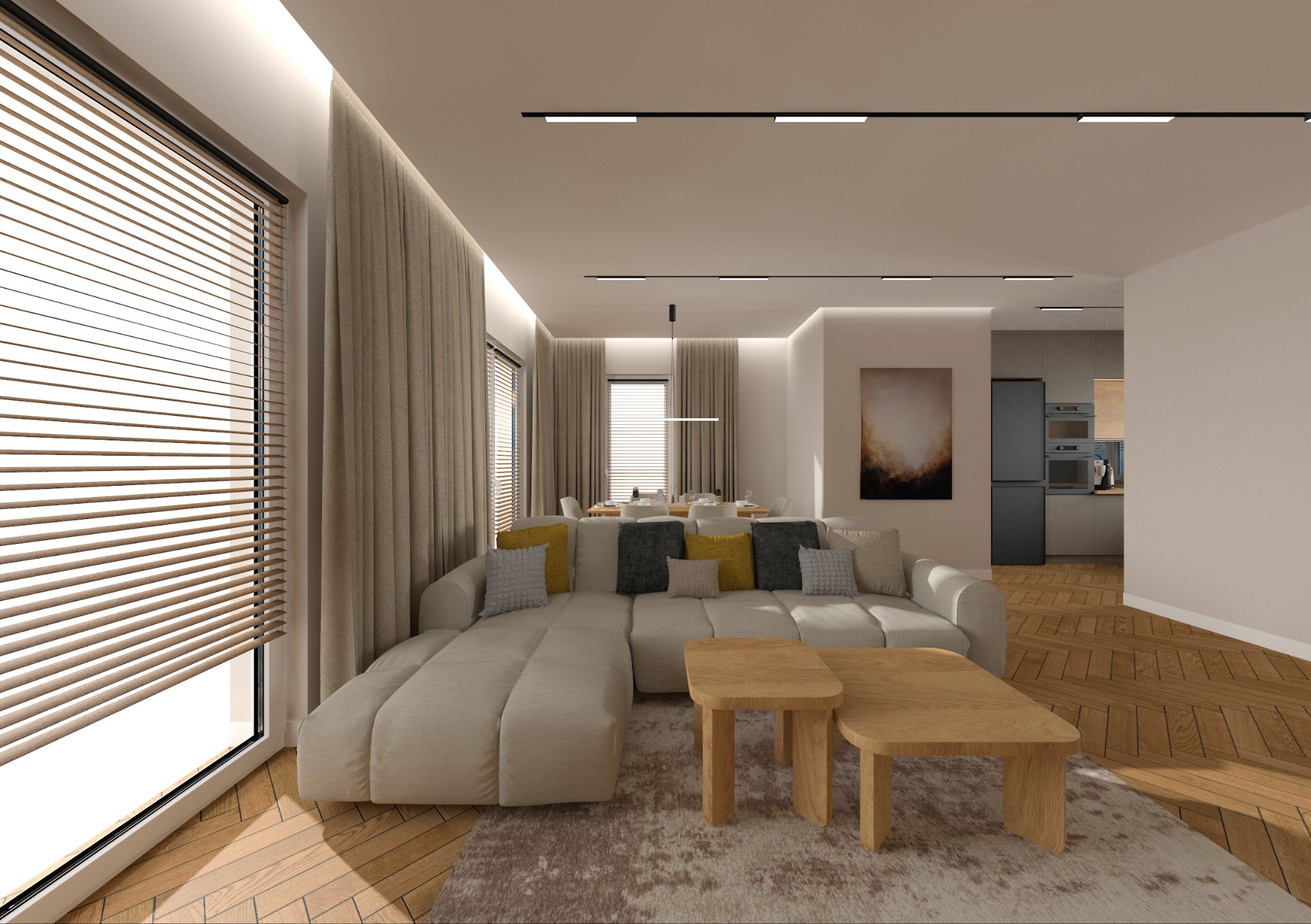 Jasne wnętrze salonu z narożną sofą, drewnianymi stolikami i parkietem. Widoczne rolety w oknach i oświetlenie sufitowe. W tle otwarta kuchnia z czarną lodówką.