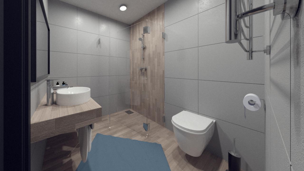 Nowoczesna łazienka z umywalką nablatową, kabiną prysznicową ze szklaną ścianą i toaletą w odcieniach szarości i drewna, uzupełniona niebieskim dywanikiem.