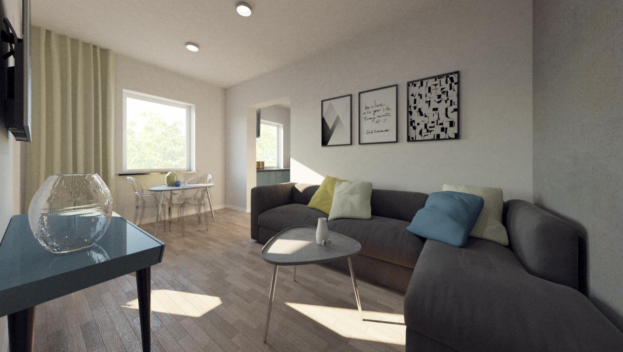 Wnętrze salonu z szarą sofą narożną, stolikiem kawowym, stołem jadalnym z krzesłami oraz dekoracjami ściennymi w postaci trzech obrazów.