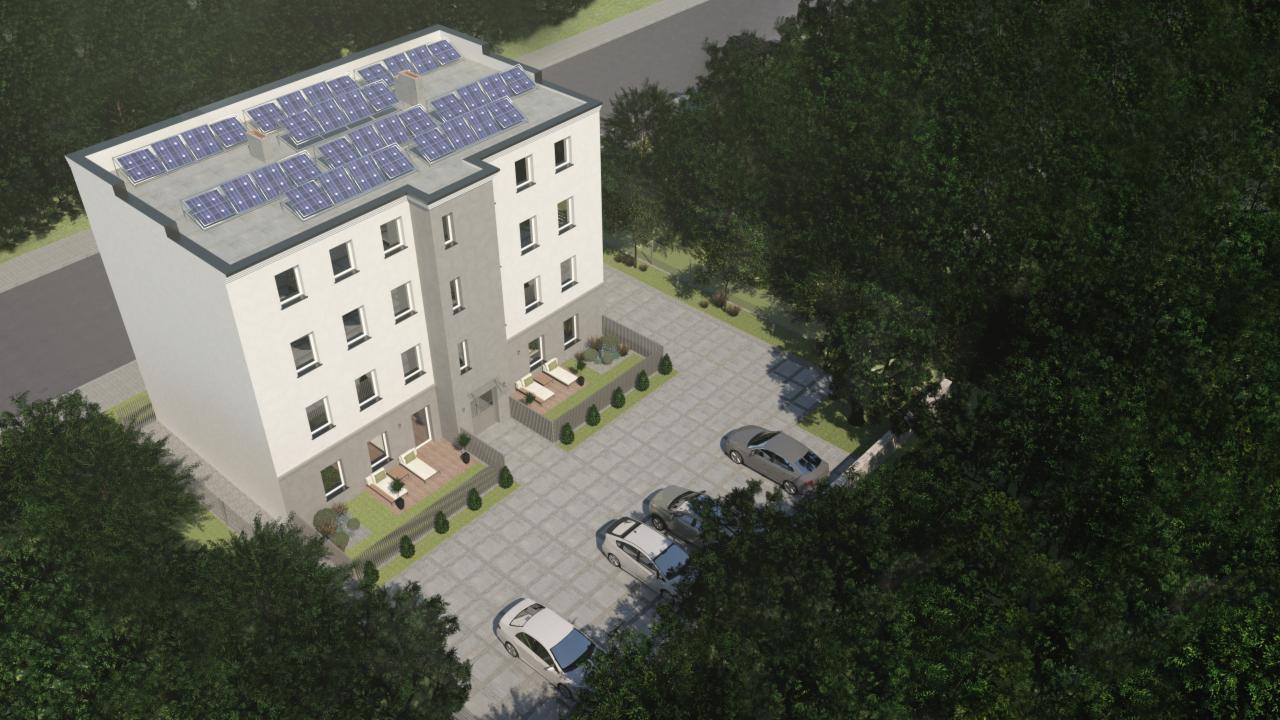 Wizualizacja budynku wielorodzinnego z panelami słonecznymi na dachu, widok z góry, z zaparkowanymi samochodami i zielenią wokół.