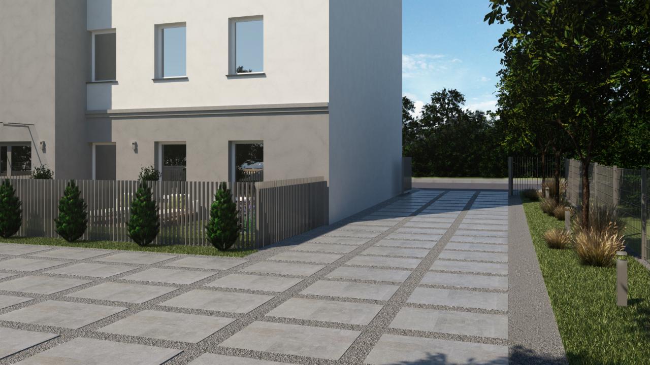 Nowoczesny podjazd z betonowych płyt oddzielonych żwirem, prowadzący do domu z szarym ogrodzeniem i równo przystrzyżonymi drzewkami.