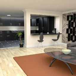 Nowoczesne wnętrze mieszkania z otwartą kuchnią, czarnymi meblami kuchennymi, szarą sofą, designerskimi krzesłami barowymi i geometryczną półką na ścianie z wzorzystą tapetą.