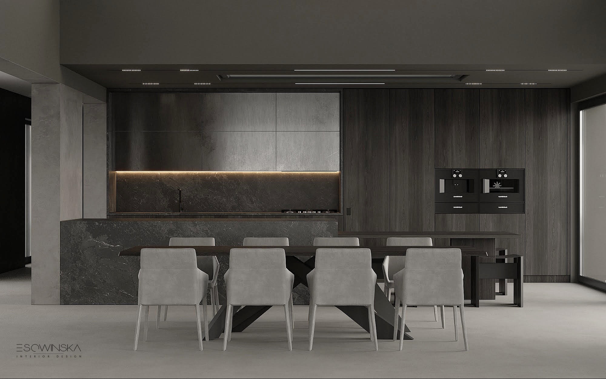 Minimalistyczna kuchnia z ciemnymi drewnianymi szafkami, marmurowym blatem podświetlonym listwą LED, szarymi krzesłami i stołem z geometryczną podstawą.
