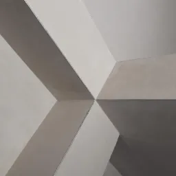 Świeżo nałożona, jasnoszara powierzchnia ściany z widocznymi, geometrycznymi załamaniami i krawędziami, tworząca nowoczesny efekt wizualny.