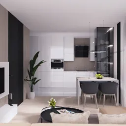 Nowoczesne wnętrze otwartej przestrzeni dziennej z kuchnią: białe szafki kuchenne, drewniane akcenty na ścianie, czarne detale, stół z szarymi krzesłami, widok z okna na jesienne drzewa.