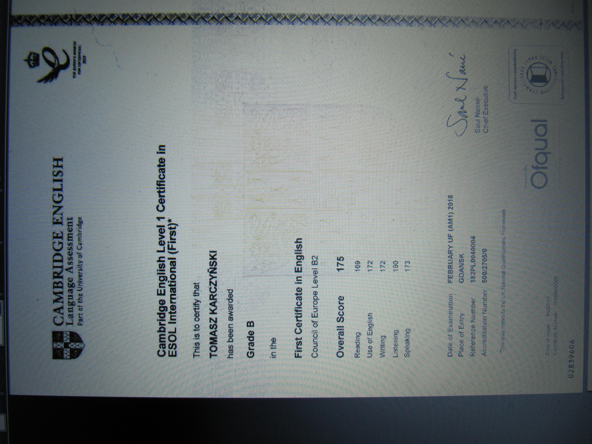 Skan certyfikatu Cambridge English Level 1 Certificate in ESOL International (First) dla Tomasza Karczyńskiego, ocena B, z wynikami szczegółowymi z poszczególnych umiejętności językowych.