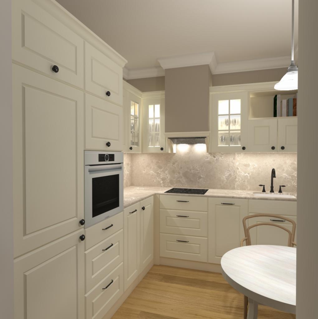 Jasna kuchnia z drewnianą podłogą i beżowym blatem, okapem oraz okrągłym stołem z krzesłem w tle.