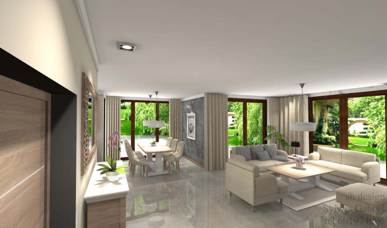 Wizualizacja przestronnego salonu z jadalnią, duże okna z widokiem na ogród, beżowe meble, marmurowa podłoga, nowoczesne oświetlenie i dekoracje, z zaznaczonym logo firmy projektowej w rogu.