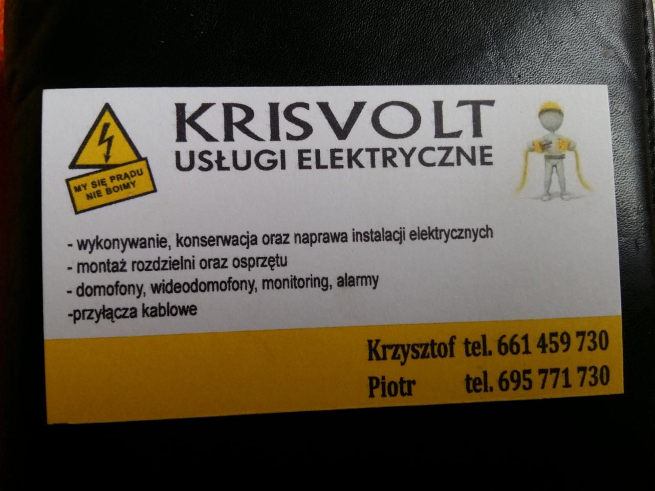 Wizytówka firmy Krisvolt Usługi Elektryczne z hasłem 'My się prądu nie boimy', oferującej wykonywanie, konserwację i naprawę instalacji elektrycznych, montaż rozdzielni i osprzętu, domofony...
