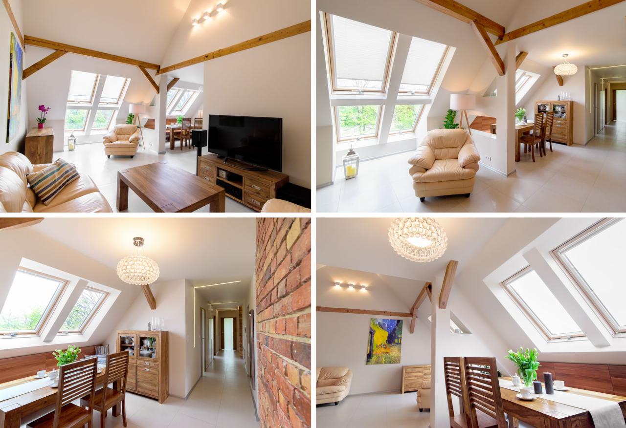 Jasne, przestronne poddasze z drewnianymi belkami, oknami dachowymi, beżową sofą, drewnianym stołem kawowym i telewizorem, widok na jadalnię z drewnianym stołem i krzesłami, oraz korytarz z ceglaną...