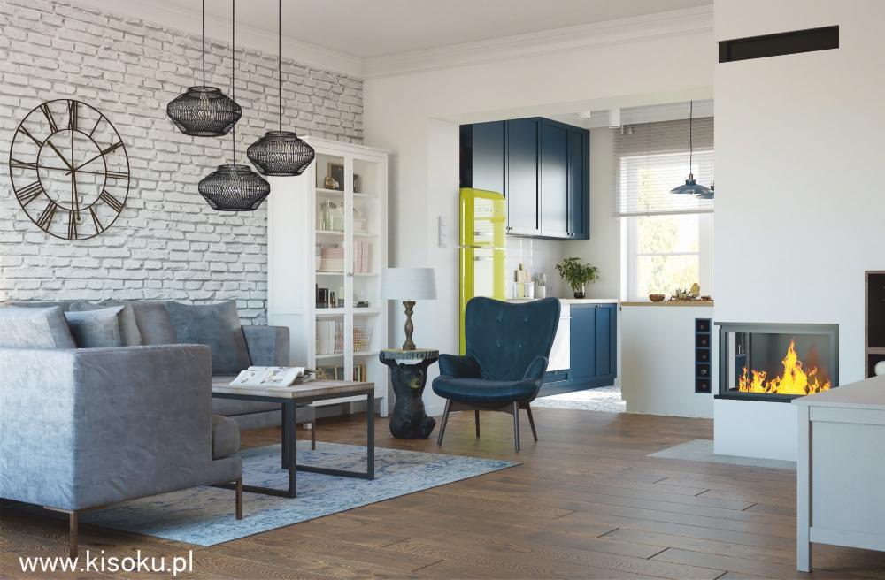 Aranżacja salonu z aneksem kuchennym w Ksawerowie: szara sofa, ażurowe lampy wiszące, ceglana ściana, błękitny fotel i limonkowy retro lodówka.